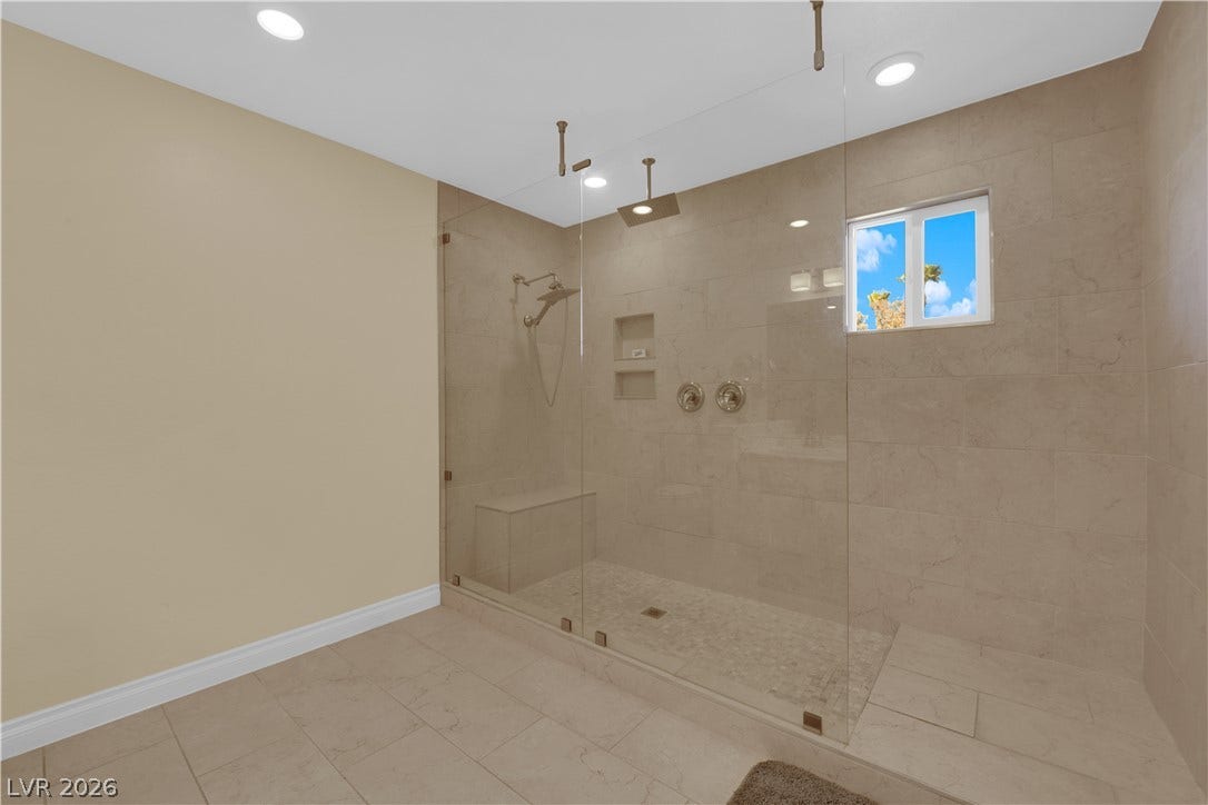 9852 Snowy Canyon Court, Las Vegas, NV 89183 A spacious walk-in shower with floor-to-ceiling tile highlights this modern bathroom.