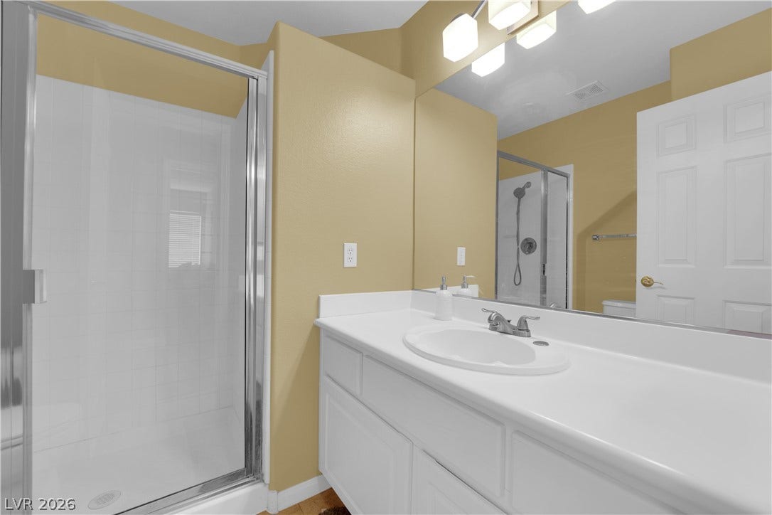 9852 Snowy Canyon Court, Las Vegas, NV 89183 A glass-enclosed walk-in shower highlights this functional bathroom spaces.