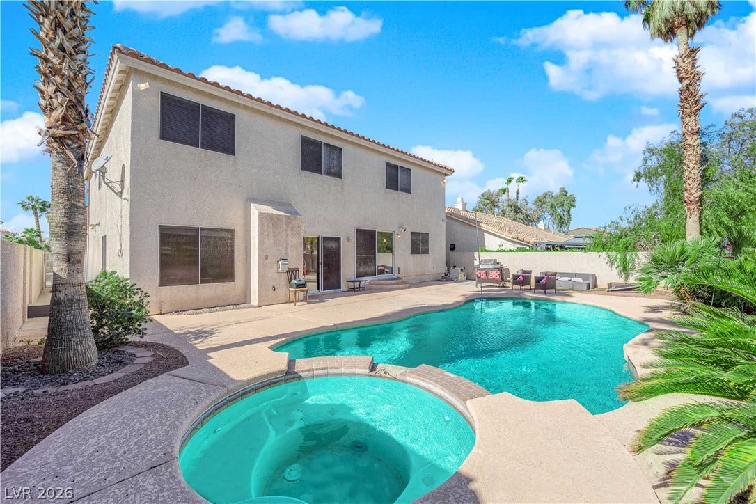 9852 Snowy Canyon Court, Las Vegas, NV 89183 An inviting backyard oasis features a sparkling swimming pool, integrated spa, and expansive concrete patio.
