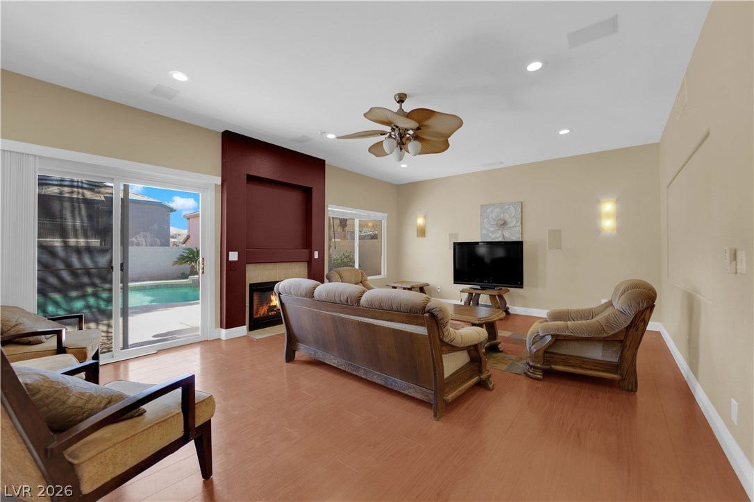 9852 Snowy Canyon Court, Las Vegas, NV 89183 Sliding glass doors open to the pool area from this inviting living room.