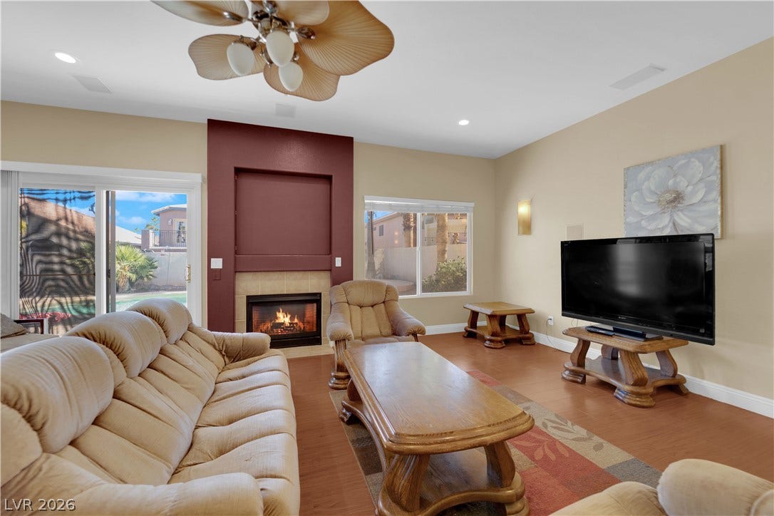 9852 Snowy Canyon Court, Las Vegas, NV 89183 An inviting fireplace serves as the centerpiece of this comfortable living space with sliding glass doors.