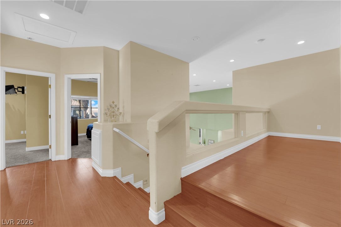 9852 Snowy Canyon Court, Las Vegas, NV 89183 Warm wood flooring and clean architectural lines define this welcoming upper level landing.