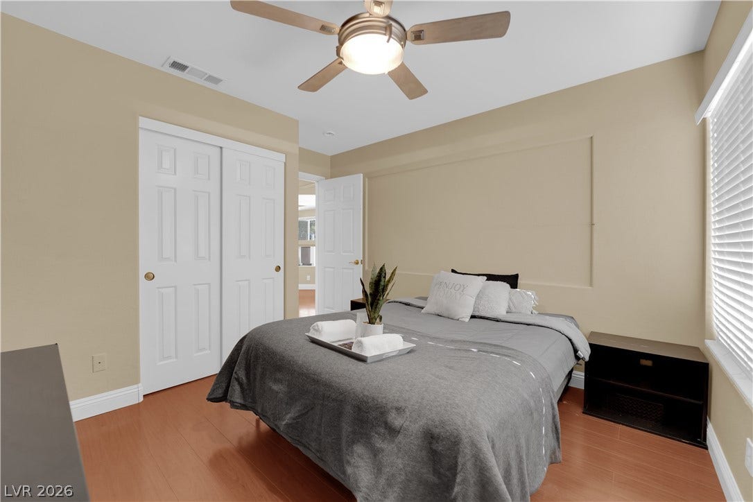 9852 Snowy Canyon Court, Las Vegas, NV 89183 Rich wood floors and clean trim define this comfortable bedroom space.
