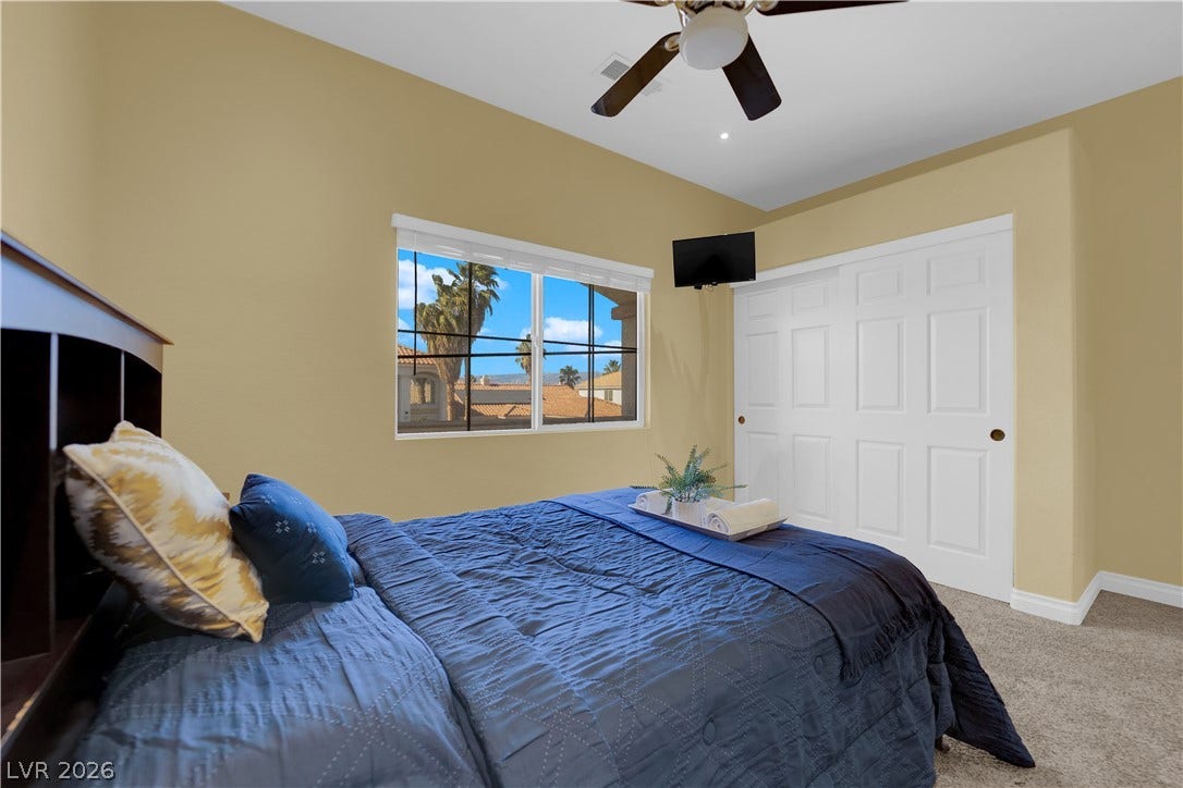 9852 Snowy Canyon Court, Las Vegas, NV 89183 Plentiful natural light streams through the window of this comfortable bedroom with soft carpeting.