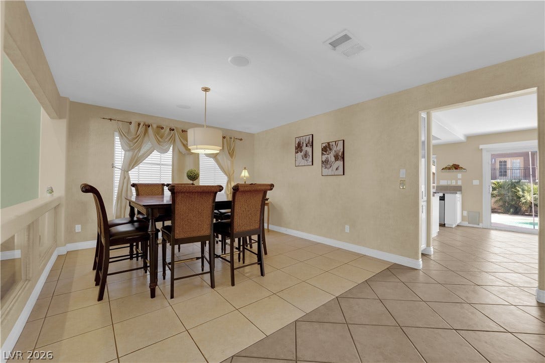 9852 Snowy Canyon Court, Las Vegas, NV 89183 Tiled flooring flows through this dining area highlighting the open architectural plan.