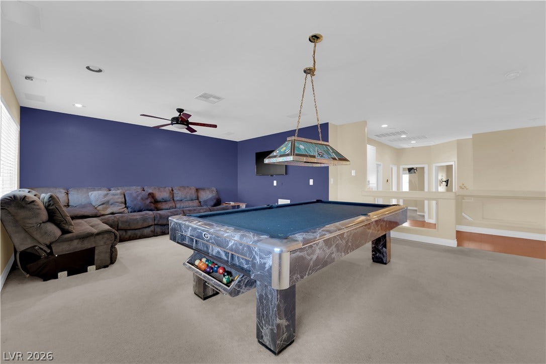 9852 Snowy Canyon Court, Las Vegas, NV 89183 Plush carpeting anchors this expansive upper-level recreation area featuring recessed lighting.