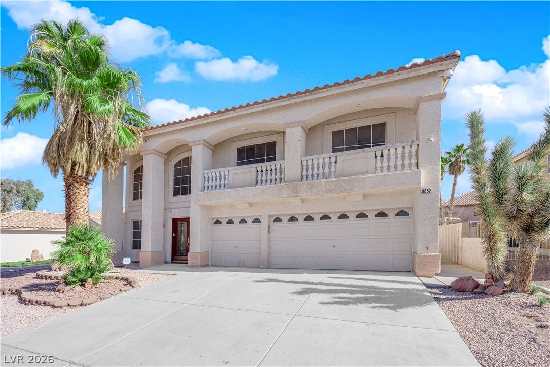 9852 Snowy Canyon Court, Las Vegas, NV 89183 Mediterranean-inspired columns and an expansive upper balcony define this striking two-story desert residence.