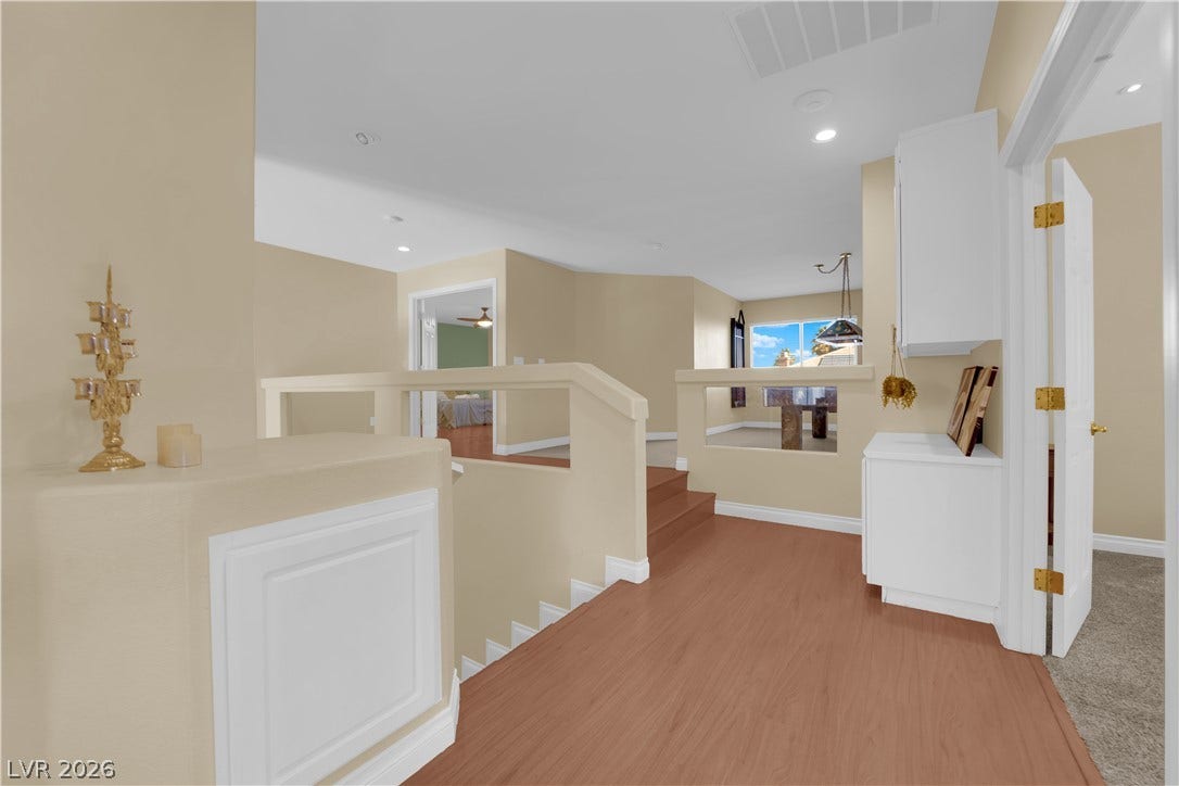 9852 Snowy Canyon Court, Las Vegas, NV 89183 Warm wood flooring and an open layout create an inviting upper-level landing space.