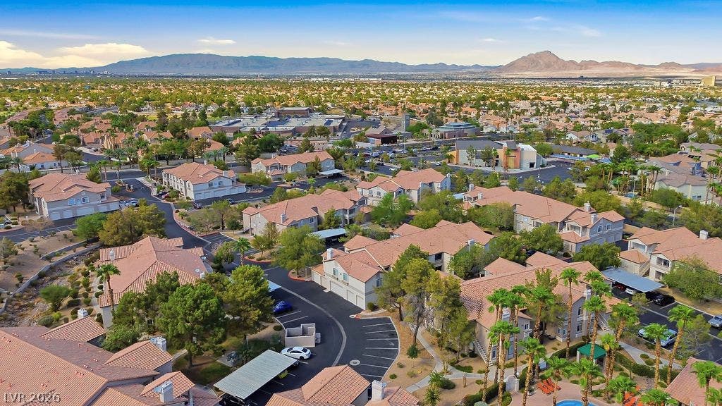 75 N Valle Verde Drive, #311, Henderson, NV 89074 An aerial perspective showcases a quiet residential neighborhood set against a desert mountain backdrop.
