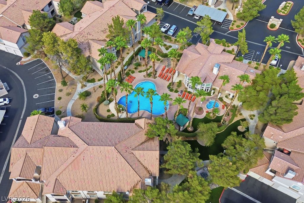 75 N Valle Verde Drive, #311, Henderson, NV 89074 An aerial view showcases tiled rooftops surrounding a resort-style community pool and spa area.