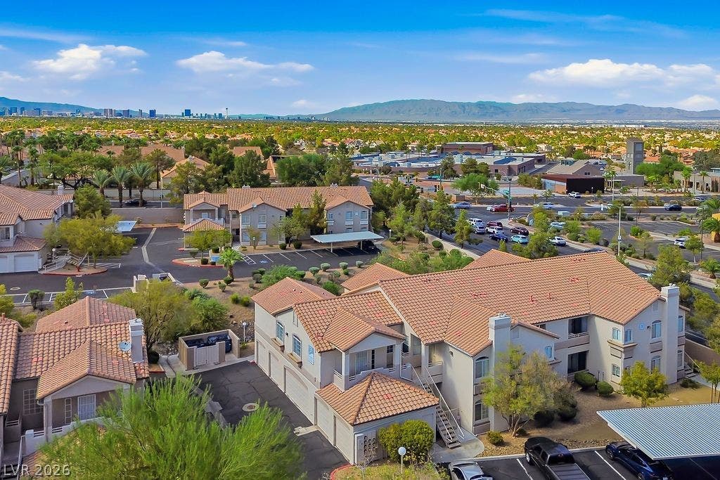 75 N Valle Verde Drive, #311, Henderson, NV 89074 Spanish tile roofs crown multi-level residential structures nestled against a dramatic mountain backdrop.