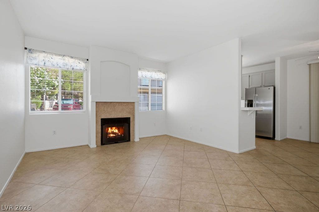 75 N Valle Verde Drive, #311, Henderson, NV 89074 A cozy fireplace anchors this open living space featuring durable tile flooring.