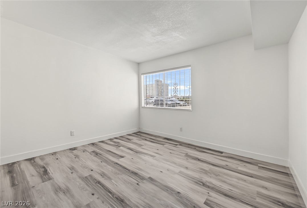 1405 Vegas Valley Drive, #187, Las Vegas, NV 89169 Natural light fills this versatile space highlighting the modern wood-look plank flooring.