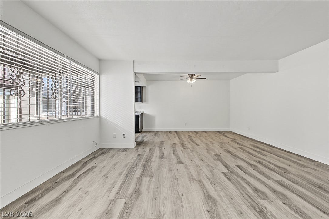 1405 Vegas Valley Drive, #187, Las Vegas, NV 89169 An open floorplan maximizes the natural light flowing across smooth wood-look laminate flooring.