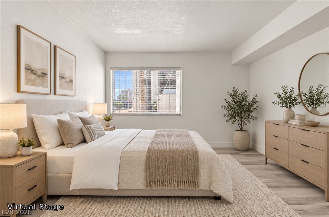 1405 Vegas Valley Drive, #187, Las Vegas, NV 89169 Smooth wood-look flooring and a wide picture window elevate this serene bedroom space.