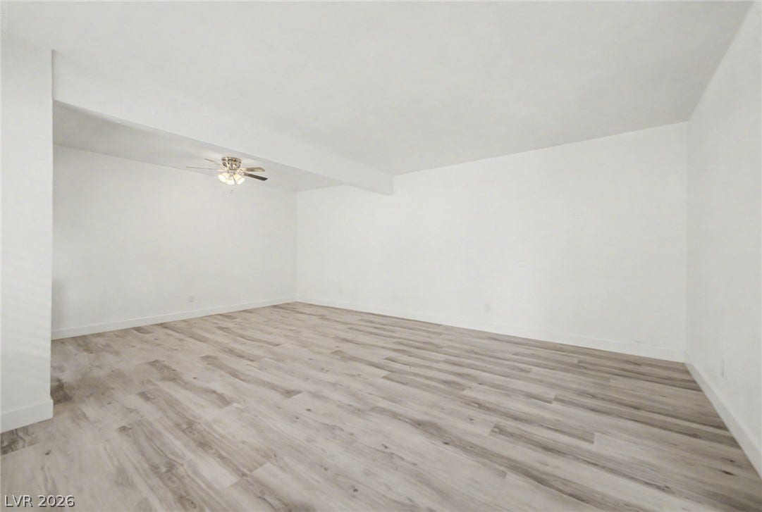1405 Vegas Valley Drive, #187, Las Vegas, NV 89169 Smooth plaster walls and wood-look flooring define this versatile interior space.