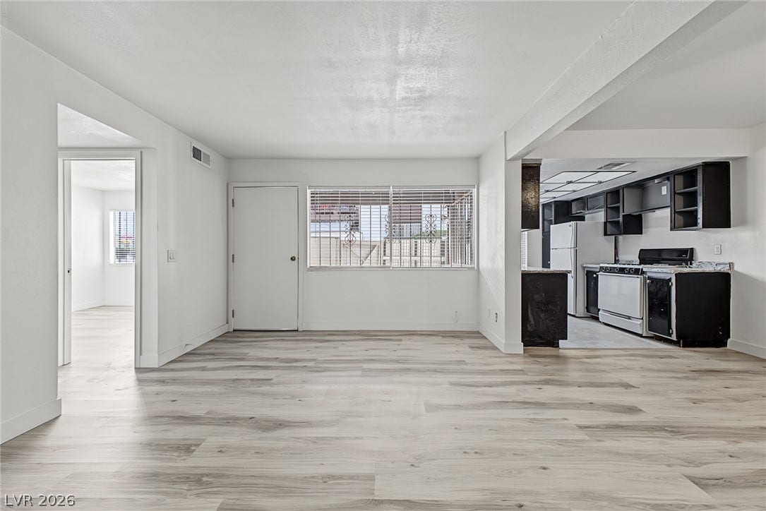 1405 Vegas Valley Drive, #187, Las Vegas, NV 89169 Smooth wood-look flooring anchors a bright open living area connected directly to the kitchen.