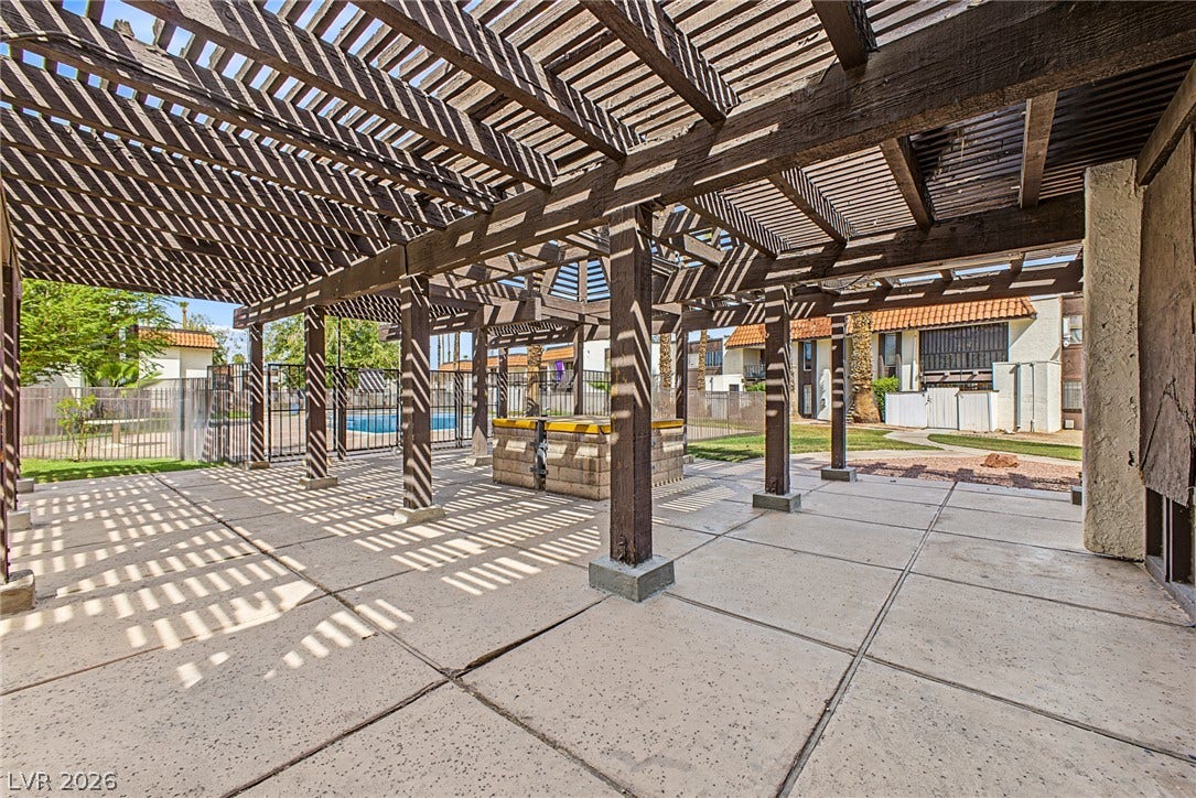 1405 Vegas Valley Drive, #187, Las Vegas, NV 89169 An expansive concrete patio lies sheltered beneath a structured wood pergola.
