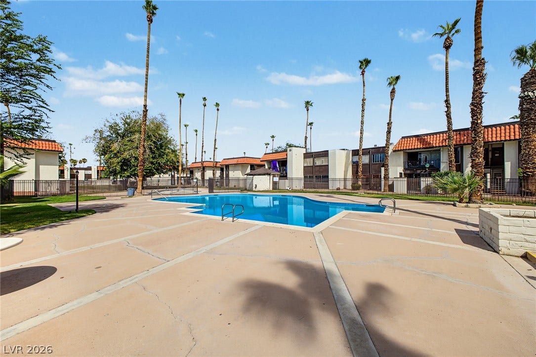 1405 Vegas Valley Drive, #187, Las Vegas, NV 89169 A sparkling community pool is framed by towering palms and Spanish tile roofs.