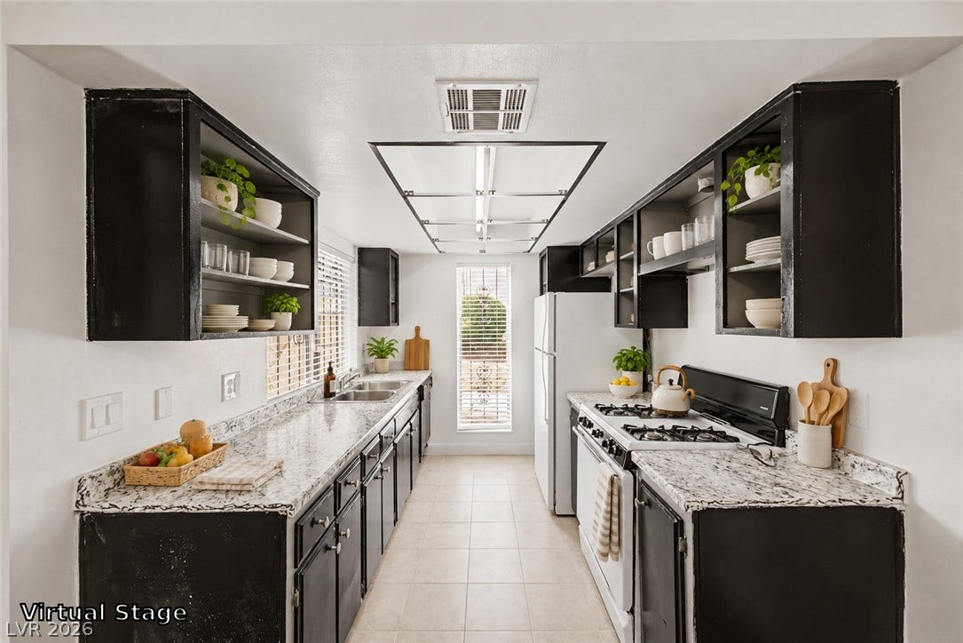 1405 Vegas Valley Drive, #187, Las Vegas, NV 89169 Granite counters and dark cabinetry define this functional galley kitchen layout.