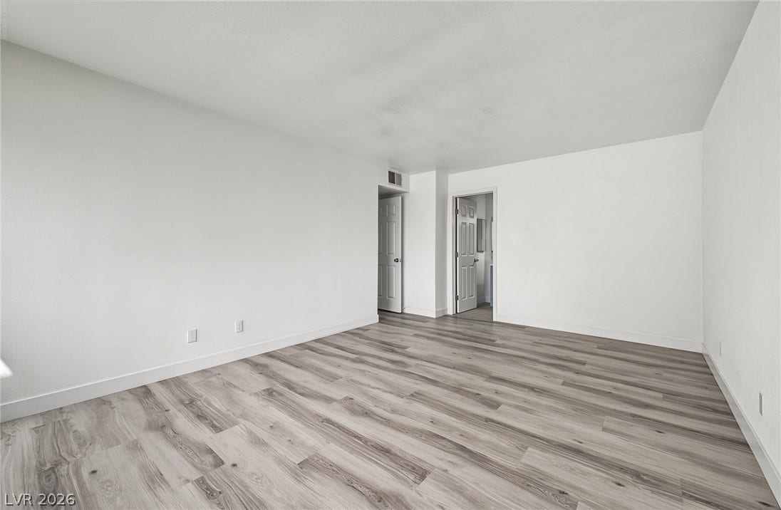 1405 Vegas Valley Drive, #187, Las Vegas, NV 89169 Gleaming wood-look floors anchor this versatile room designed with neutral walls.