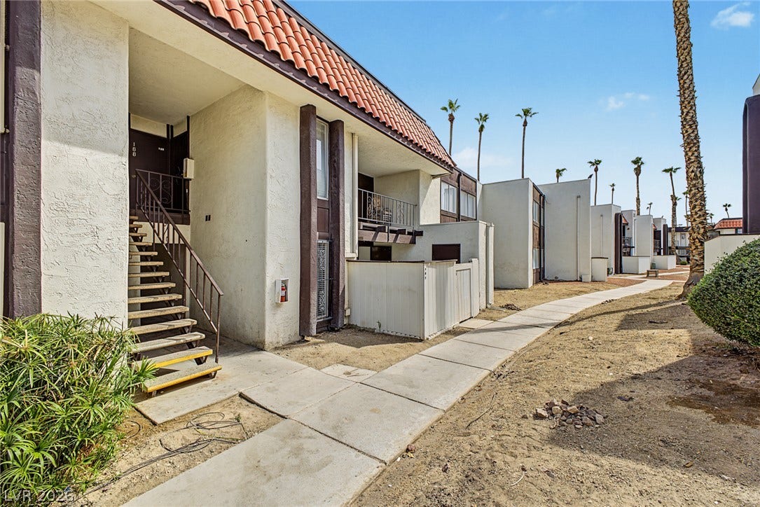 1405 Vegas Valley Drive, #187, Las Vegas, NV 89169 A concrete walkway leads to private entrances and stairways lined with Spanish tile accents.