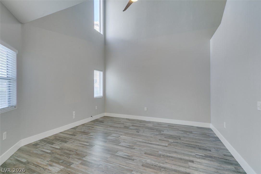 2001 Jade Creek Street, #105, Las Vegas, NV 89117 Towering ceilings and clean-lined wood-look flooring establish a grand sense of volume.