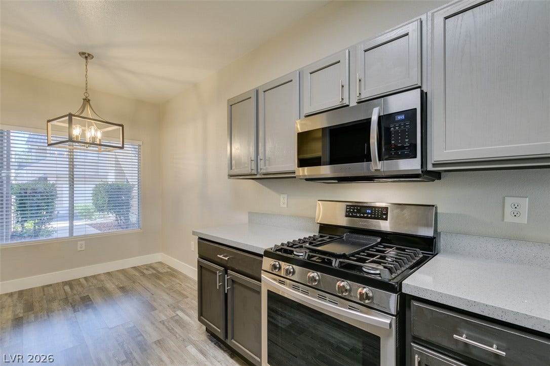 2001 Jade Creek Street, #105, Las Vegas, NV 89117 A window fills the casual dining area with natural light beside a modern cooking station.