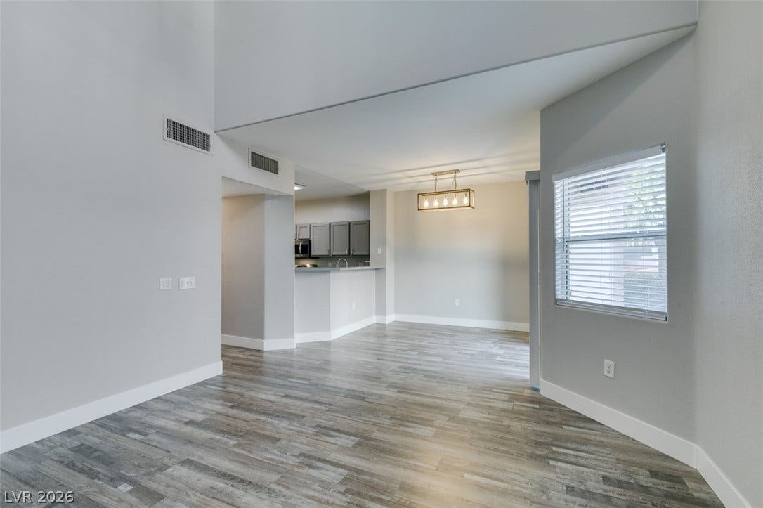 2001 Jade Creek Street, #105, Las Vegas, NV 89117 Soaring high ceilings and durable wood-look flooring define this versatile, open-concept living space.