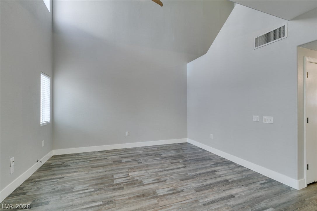 2001 Jade Creek Street, #105, Las Vegas, NV 89117 High vaulted ceilings and wood-look flooring define this versatile, light-filled interior space.