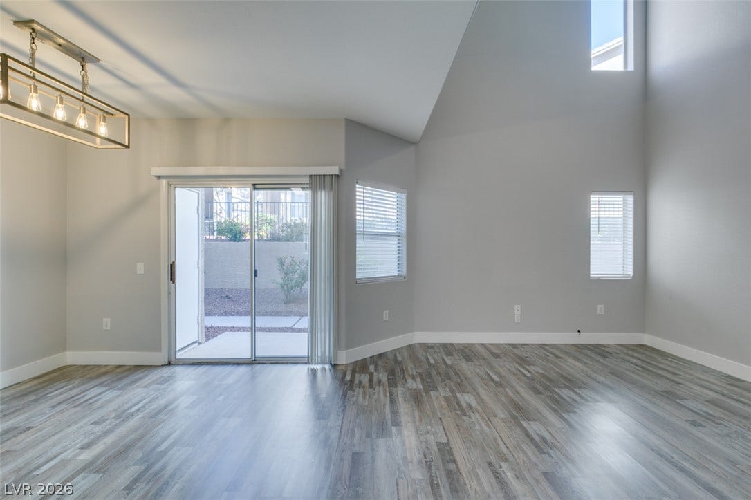 2001 Jade Creek Street, #105, Las Vegas, NV 89117 Dramatic vaulted ceilings and durable wood-look flooring define this open living area.