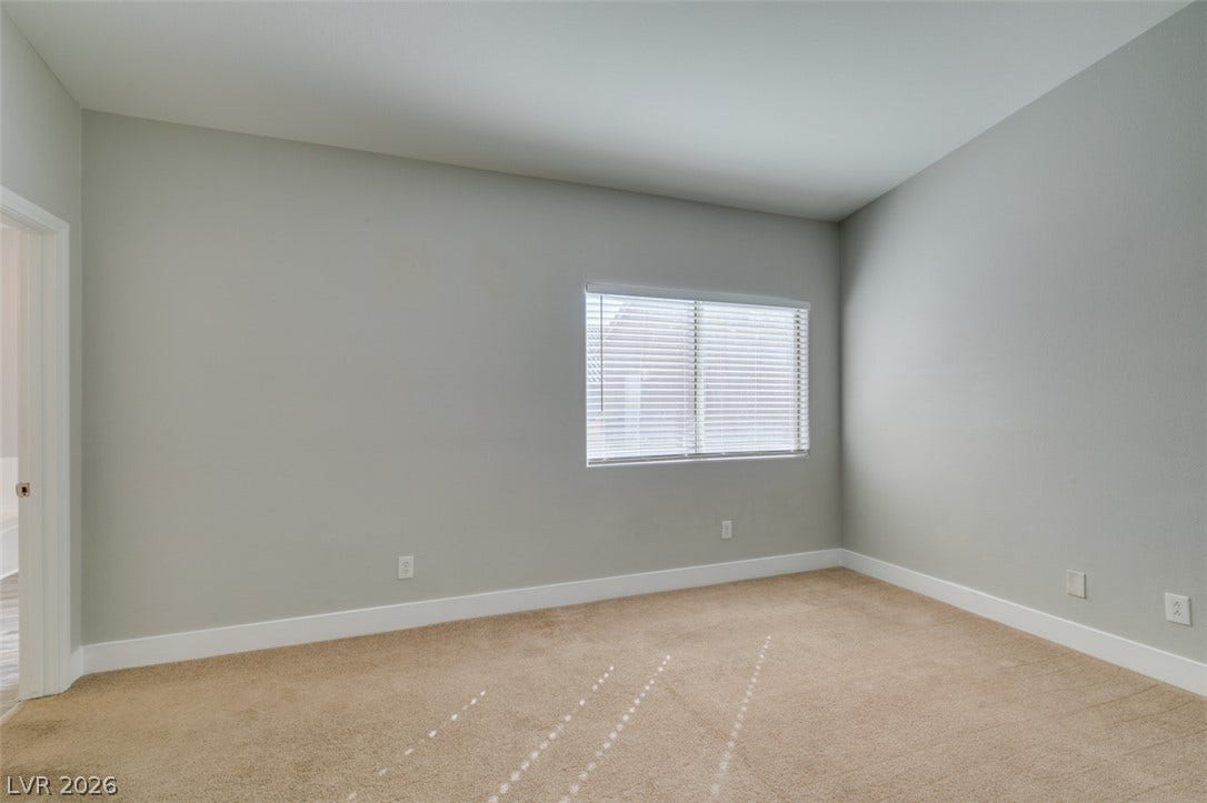 2001 Jade Creek Street, #105, Las Vegas, NV 89117 Plush neutral carpeting and clean wall profiles create a versatile secondary bedroom space.