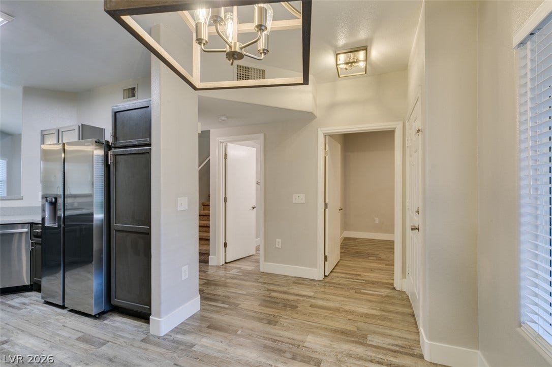 2001 Jade Creek Street, #105, Las Vegas, NV 89117 Gleaming wood floors anchor an open transition between the kitchen and main living spaces.