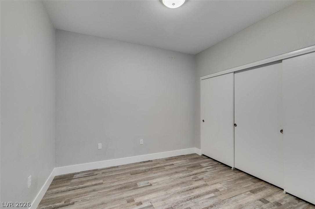 2001 Jade Creek Street, #105, Las Vegas, NV 89117 DOWNSTAIRS- Smooth wood-look flooring and integrated sliding closet doors define this versatile space.