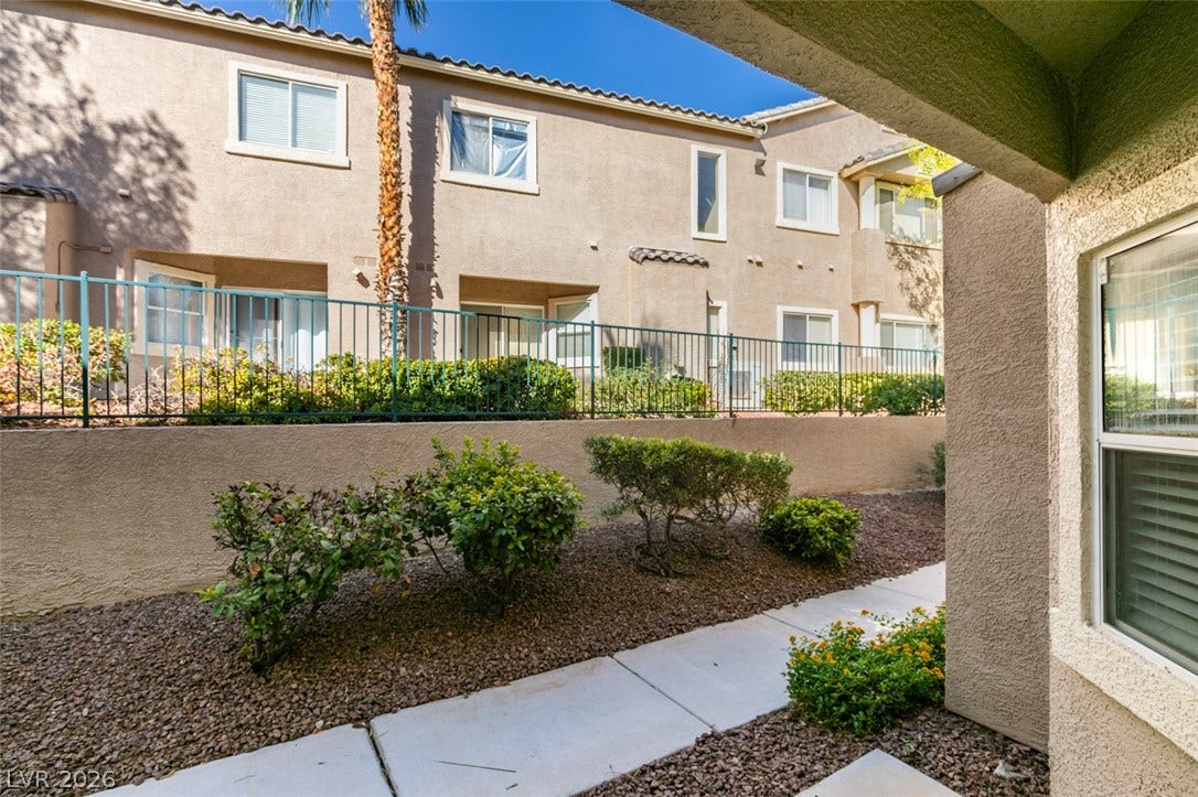 2001 Jade Creek Street, #105, Las Vegas, NV 89117 Concrete walkways meander through neatly landscaped grounds bordered by protective fencing.