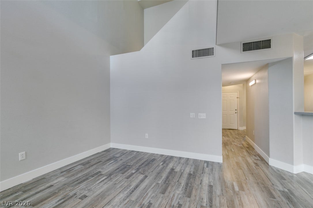 2001 Jade Creek Street, #105, Las Vegas, NV 89117 High vaulted ceilings and modern wood-look flooring define this open living space.