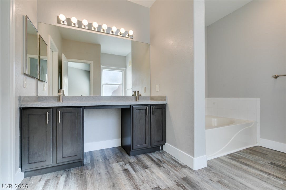 2001 Jade Creek Street, #105, Las Vegas, NV 89117 Clean lines and a spacious dual vanity highlight this modern bathroom space.