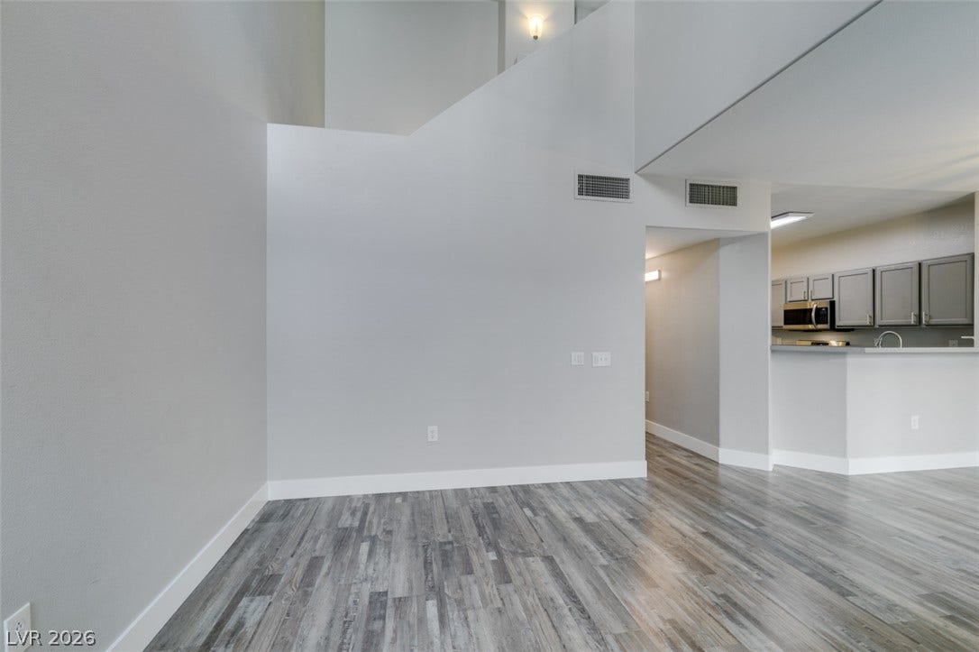 2001 Jade Creek Street, #105, Las Vegas, NV 89117 Soaring ceilings and clean-lined wood-look flooring establish an airy ambience across this open floorplan.
