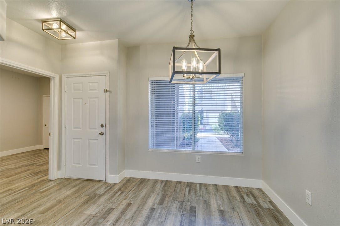 2001 Jade Creek Street, #105, Las Vegas, NV 89117 Clean lines and wood-look flooring define this welcoming entryway and dining area.