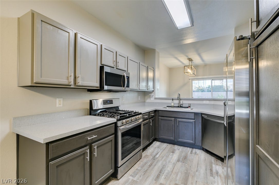 2001 Jade Creek Street, #105, Las Vegas, NV 89117 Two-tone cabinetry and solid-surface countertops define this modern cooking space.