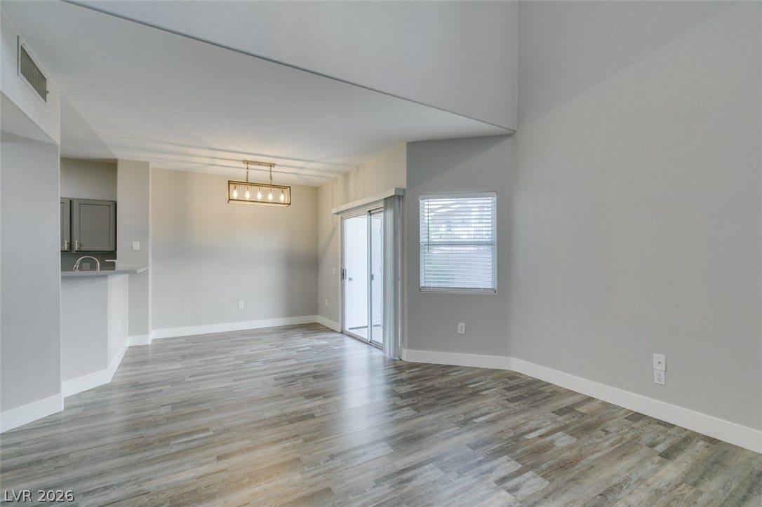 2001 Jade Creek Street, #105, Las Vegas, NV 89117 High ceilings and durable wood-look flooring enhance this versatile, open living and dining area.