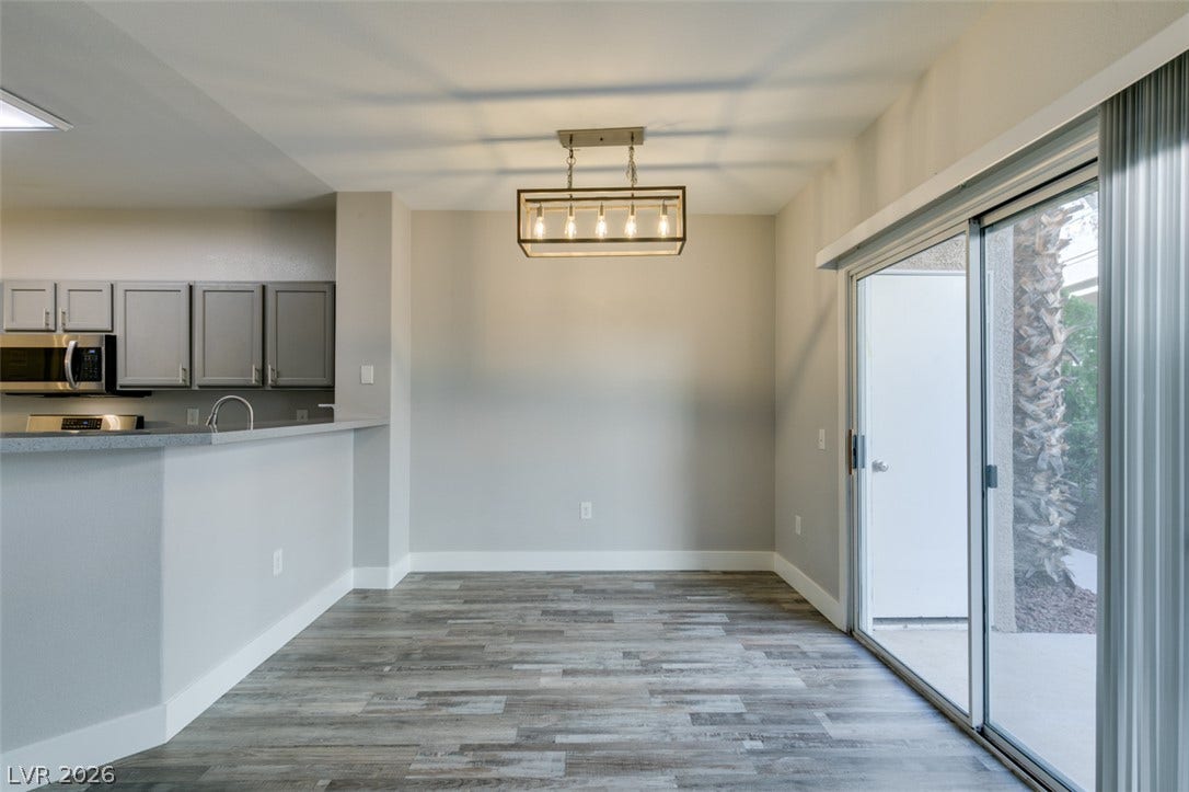 2001 Jade Creek Street, #105, Las Vegas, NV 89117 Sliding glass doors open directly to the outdoors from this versatile dining area.