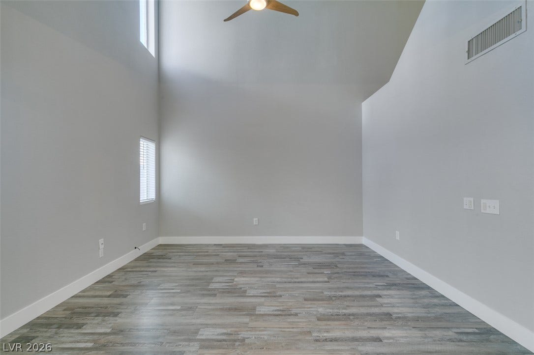 2001 Jade Creek Street, #105, Las Vegas, NV 89117 Dramatic vaulted ceilings and modern plank flooring highlight this versatile, open living area.