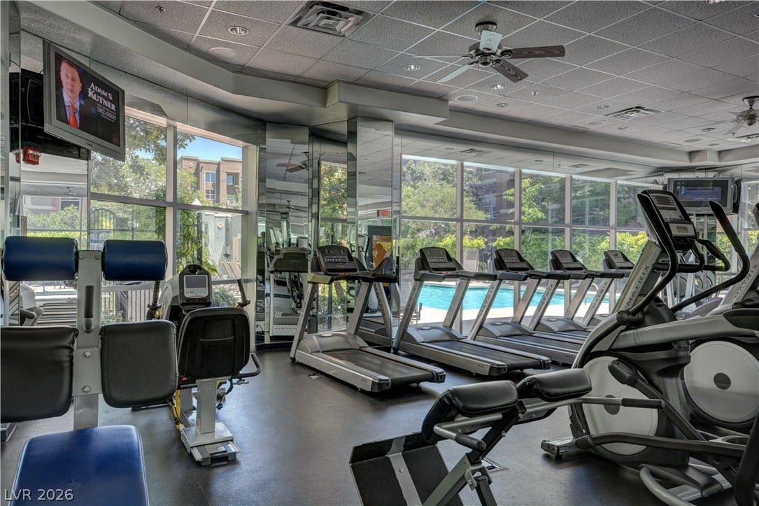 Floor-to-ceiling windows overlook the pool from this modern fitness facility with professional-grade exercise equipment.