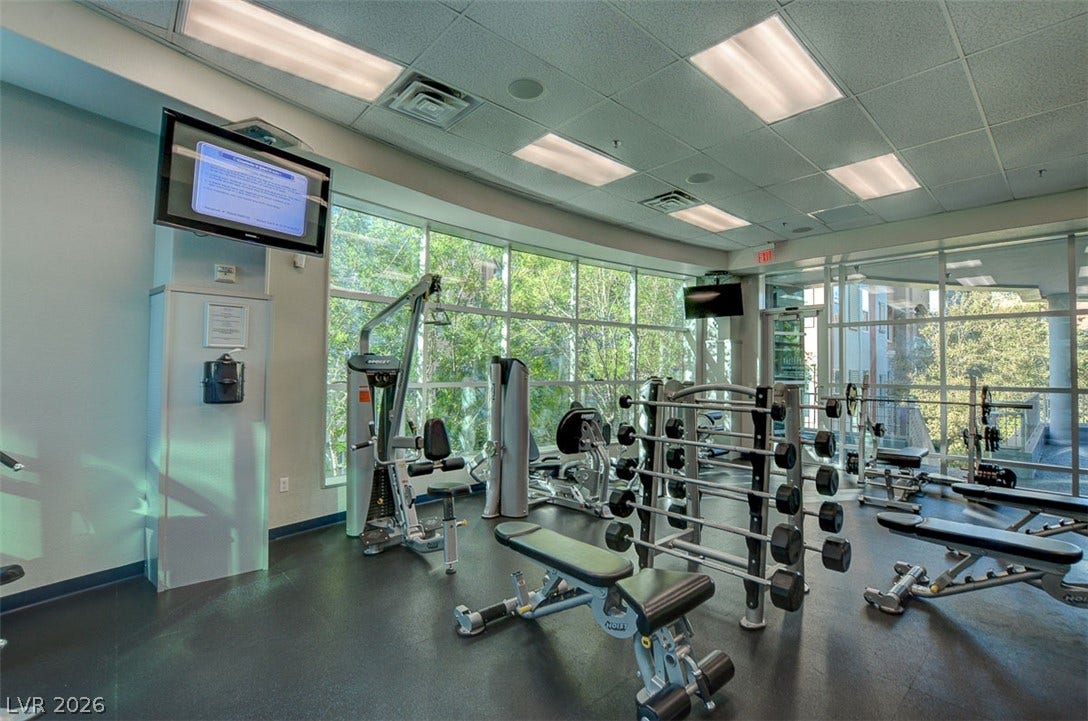 Floor-to-ceiling windows fill the private exercise room with natural light.
