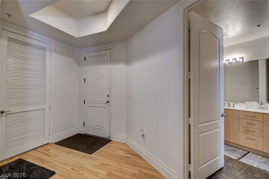 Hardwood floors and crisp white walls create an inviting entrance foyer.