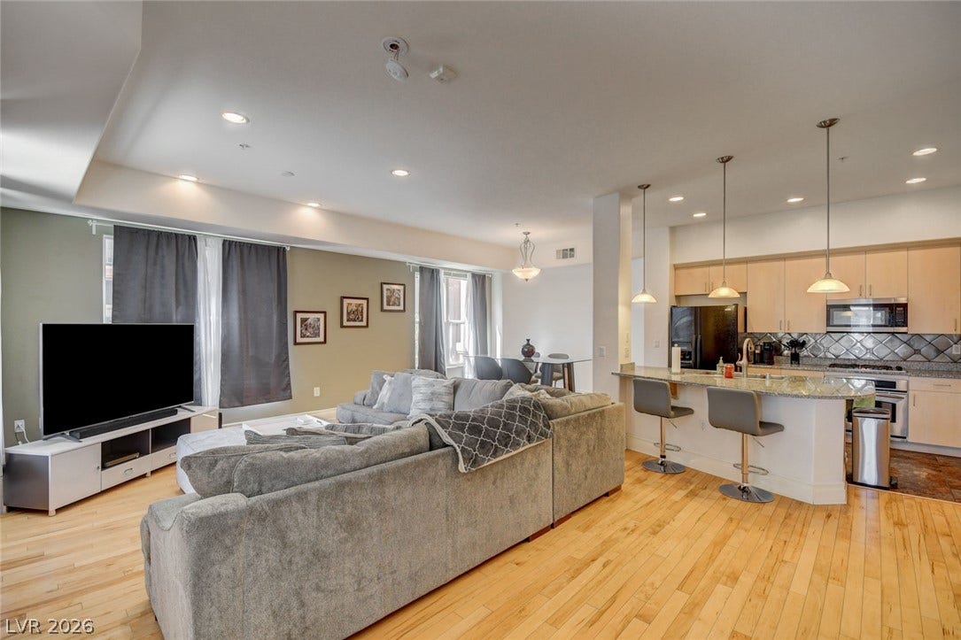 An open floorplan seamlessly connects the warm hardwood flooring from the living area into the kitchen.