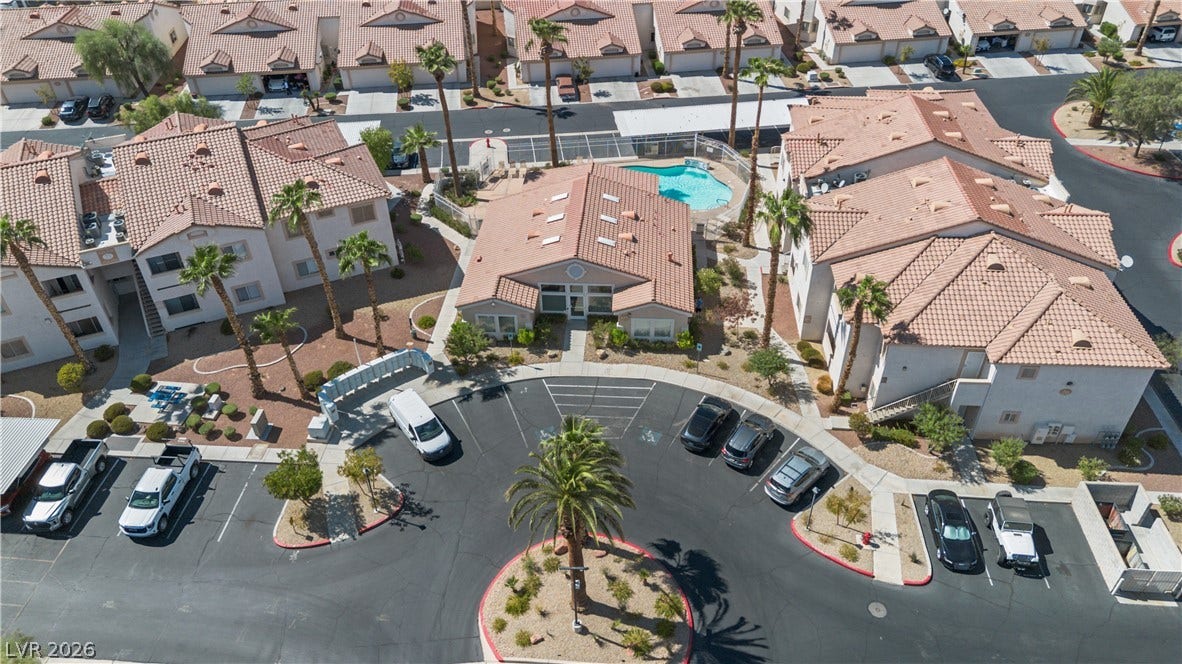 855 N Stephanie Street, #2615, Henderson, NV 89014 An aerial perspective showcases a neat residential community with tile roofs and a central pool.