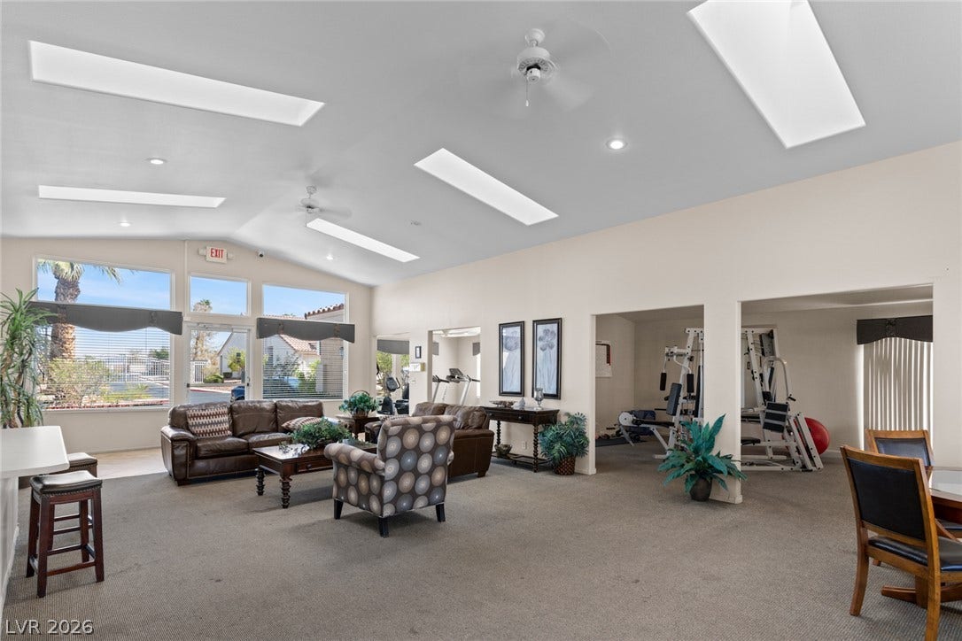 855 N Stephanie Street, #2615, Henderson, NV 89014 Skylights and large windows illuminate a sprawling recreation hall with carpeted flooring.