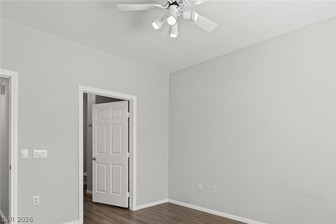 855 N Stephanie Street, #2615, Henderson, NV 89014 An open doorway reveals beautiful wood flooring stretching across this comfortable room.